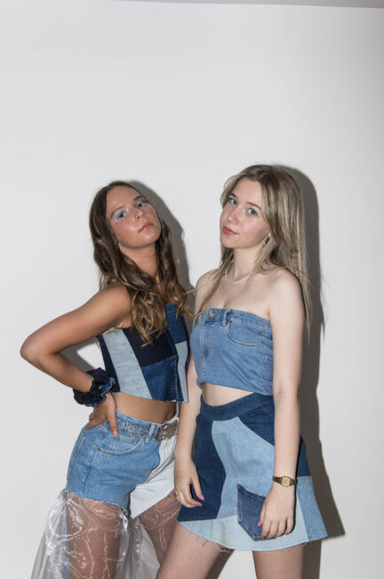 Twee modellen in tweedehands denim outfits met gepersonaliseerde jeansstukken